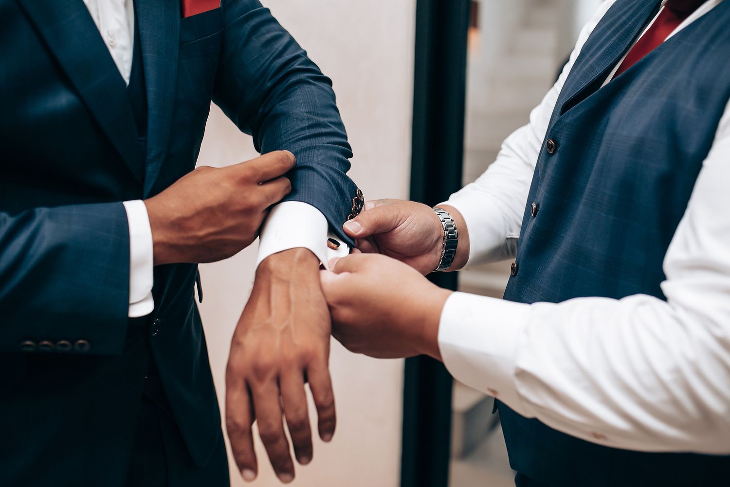Professional hands exchanging business cards during a formal meeting.