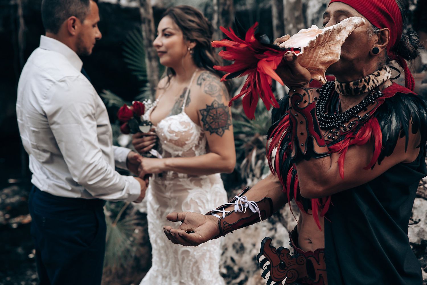 A traditional wedding blessing ritual being performed outdoors with red decorative elements.