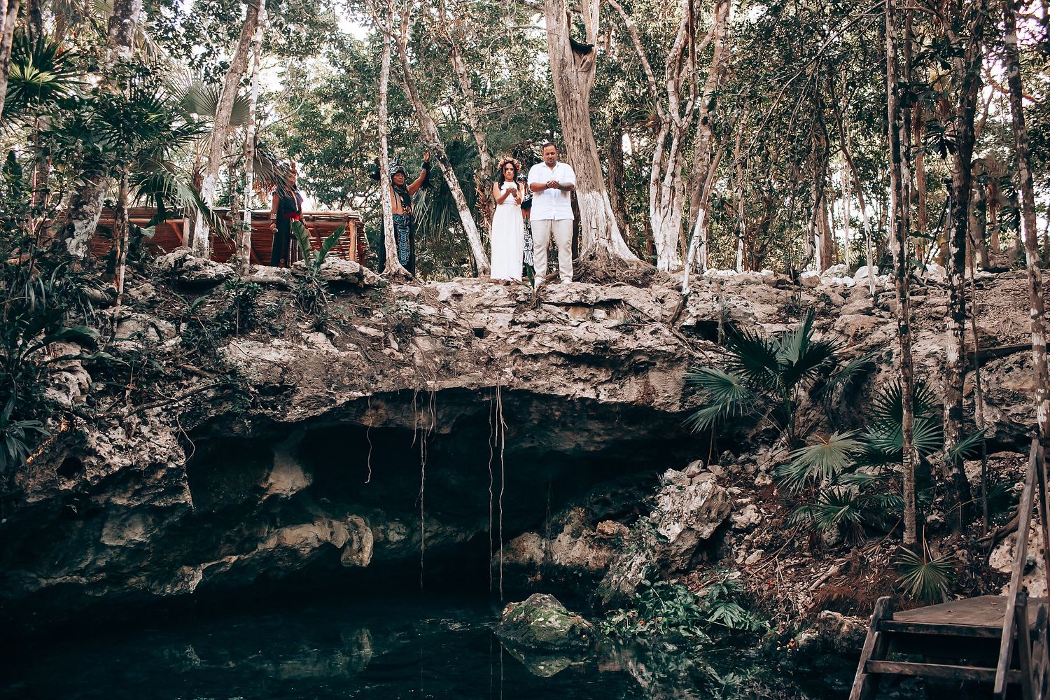 Natural cave setting decorated with traditional Mayan ceremonial elements and textiles.