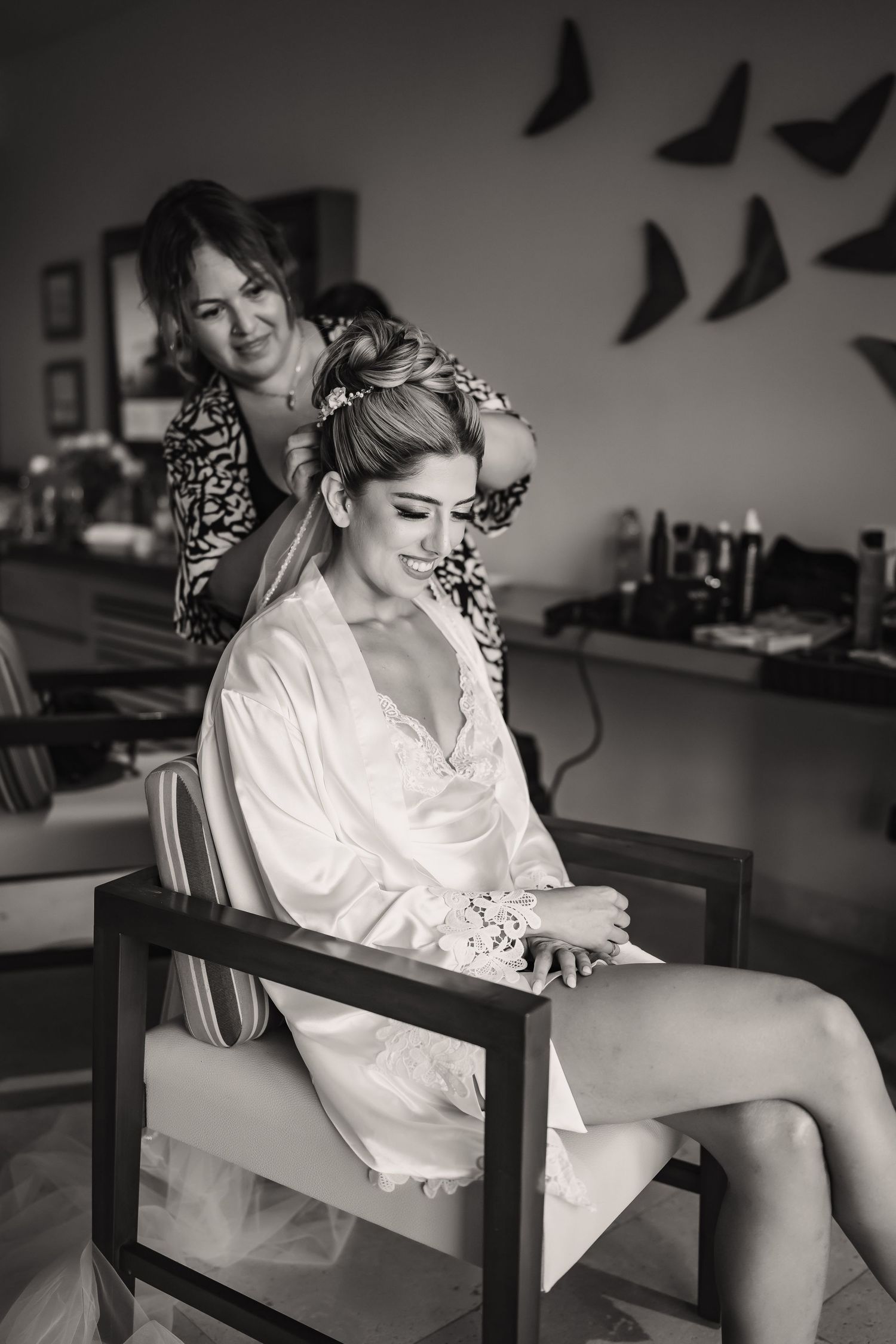 Black and white wedding preparation photo in minimalist setting.