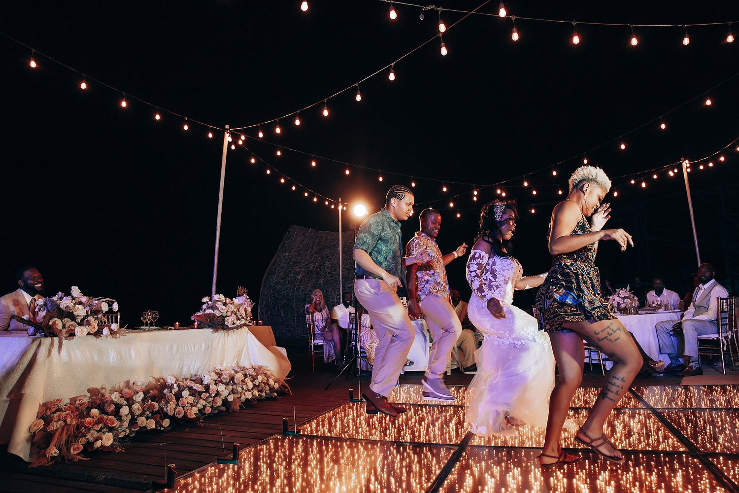 Evening wedding reception with string lights creating a romantic ambiance.