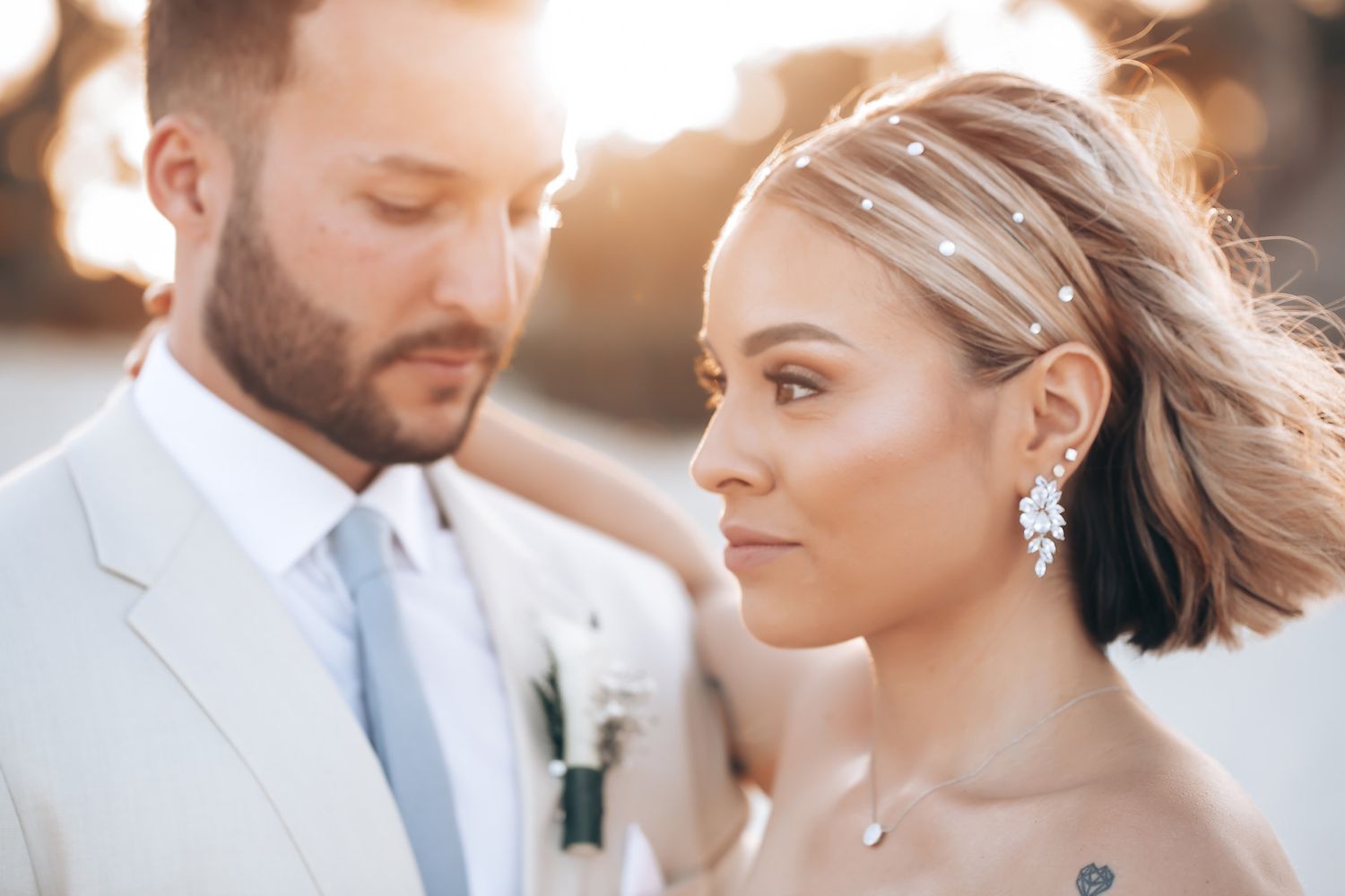 Romantic wedding portraits captured in soft golden sunlight.