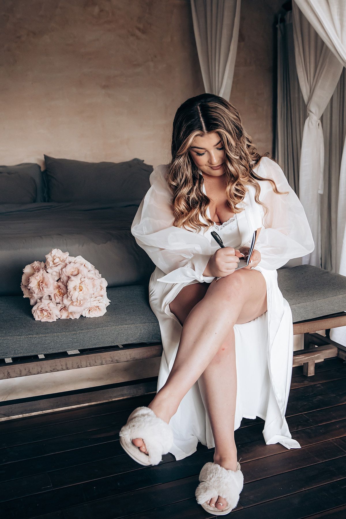 A series of boudoir photos showing legs in white slippers against a dark wooden floor with soft white fabric.