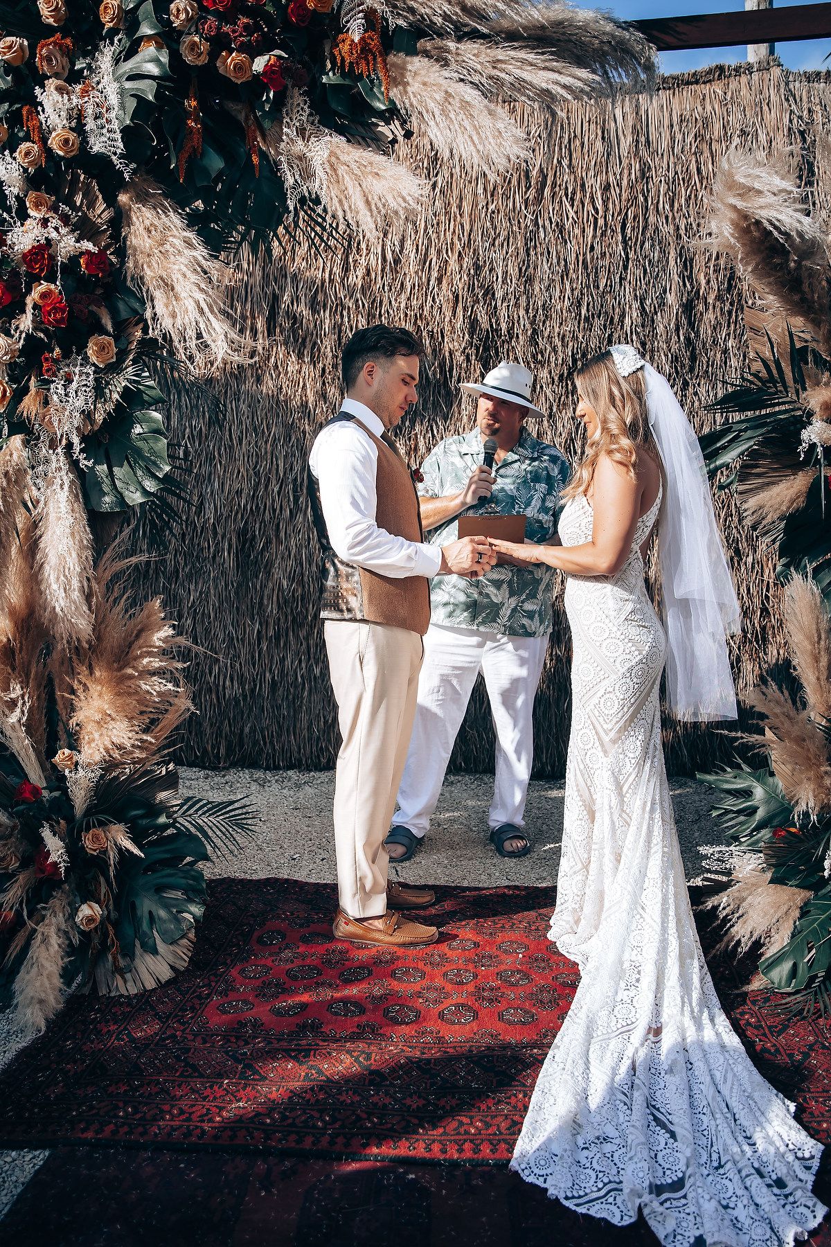 A sequence of wedding photos showing a couple in white dancing and embracing under a tropical thatched roof structure.