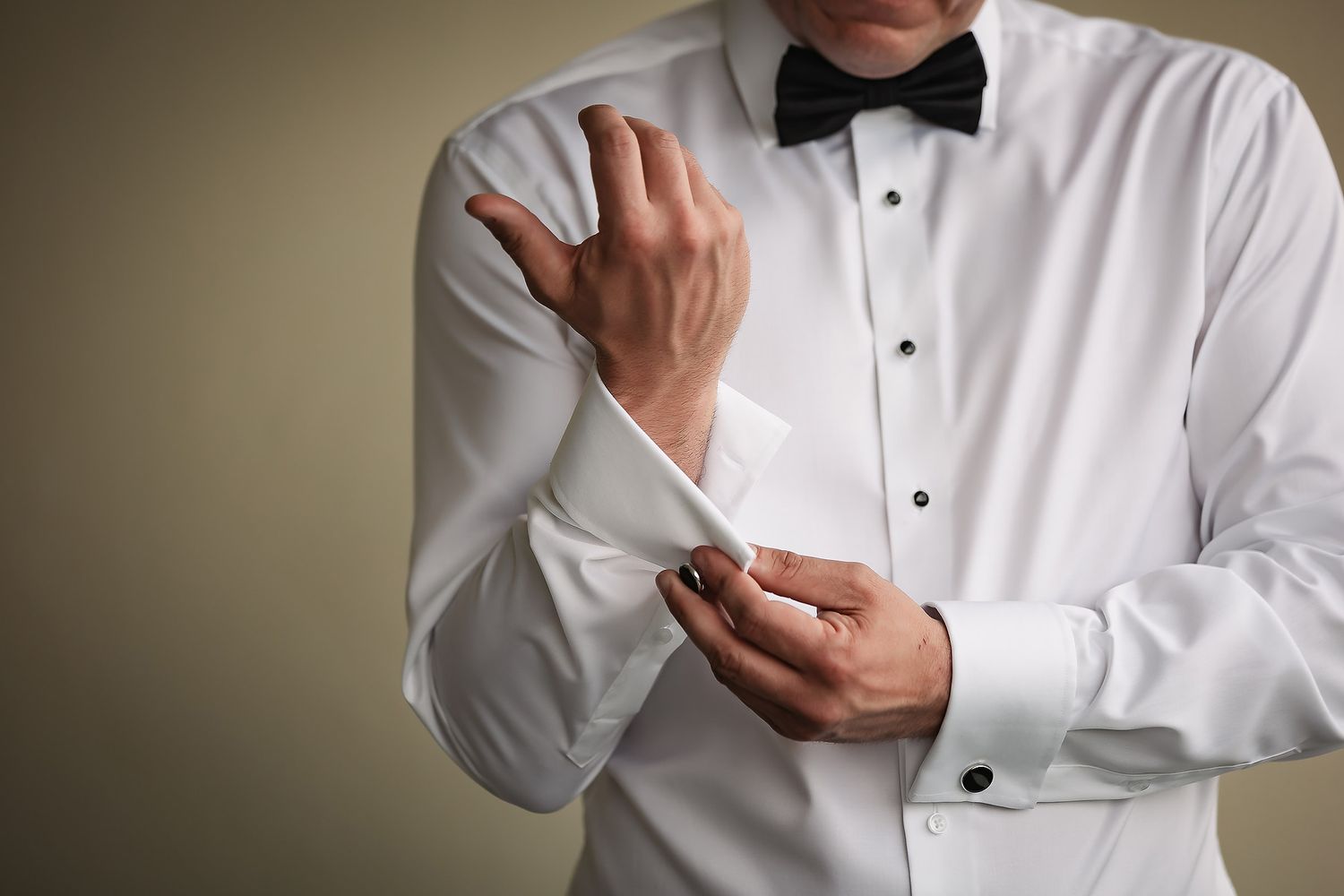 Person in white dress shirt adjusts their sleeve cuff in a series of close-up photos.