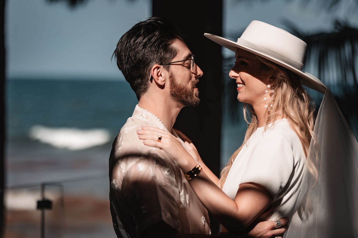 Artistic wedding photography sequence showing couple's intimate moments in moody lighting.