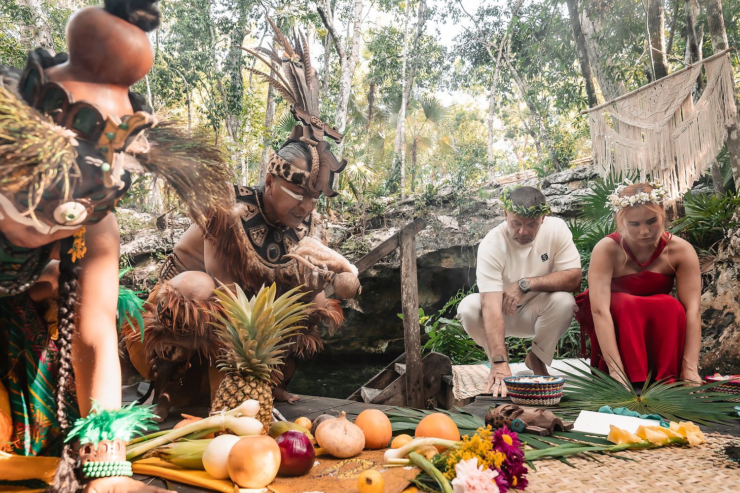 Traditional ceremony setup with fruits and ritual objects in a natural forest clearing.