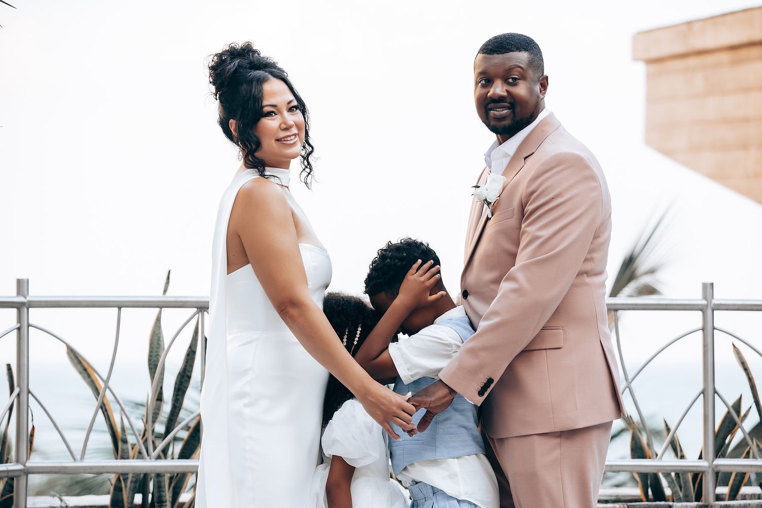 Romantic outdoor wedding photoshoot with couples in white and beige attire.