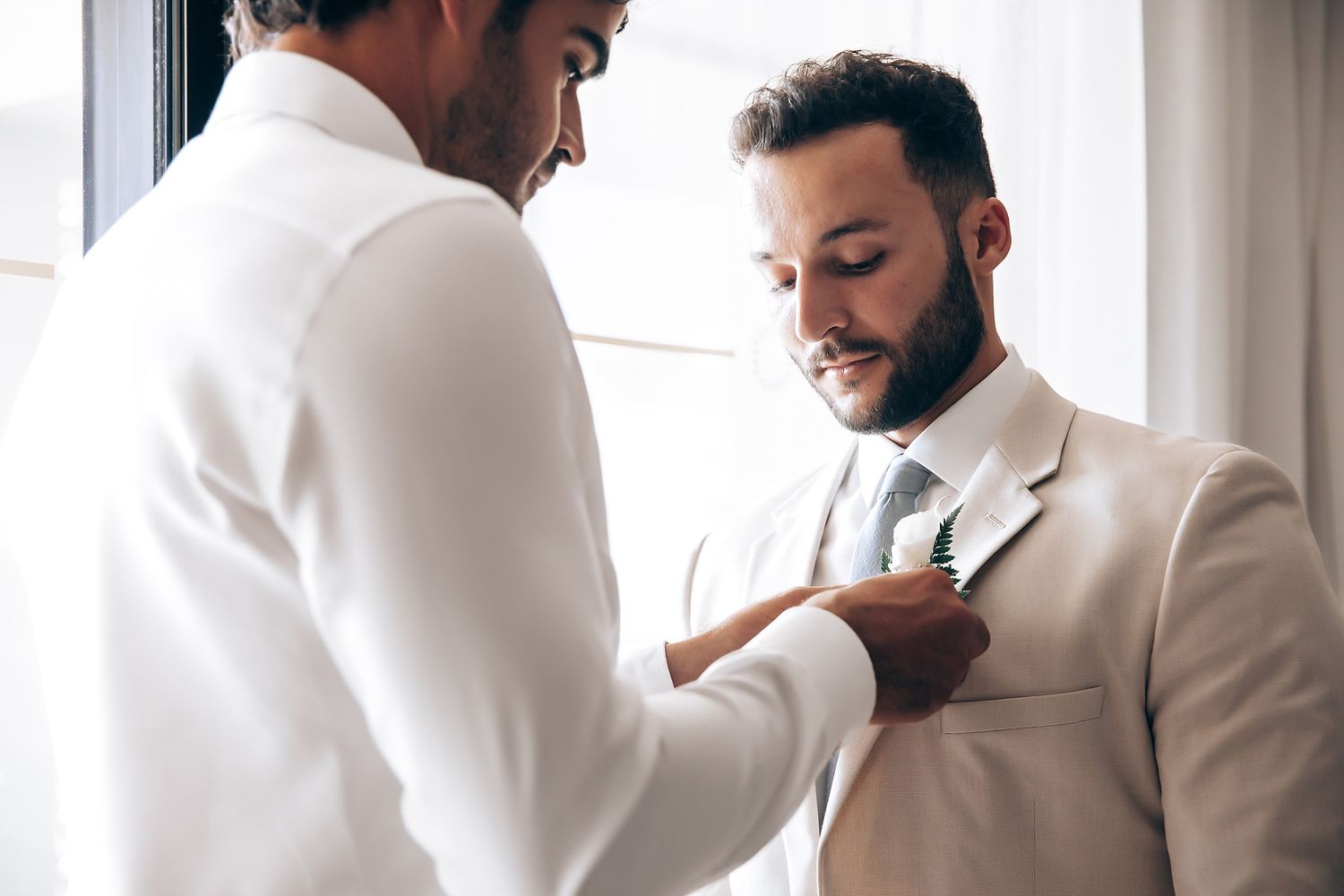 Getting ready sequence showing formal attire preparation in natural window light.