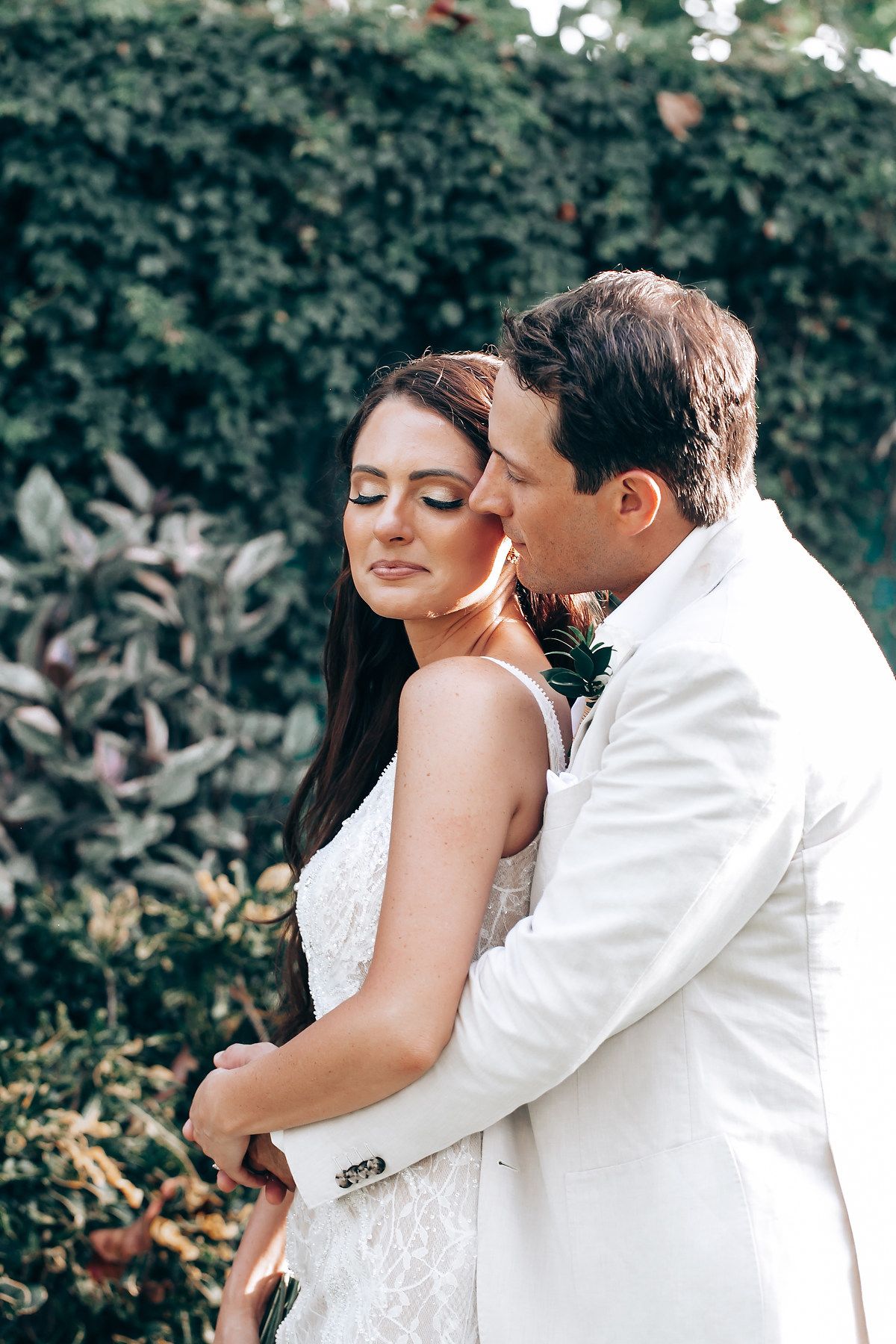 Intimate wedding portrait session in a lush garden setting.