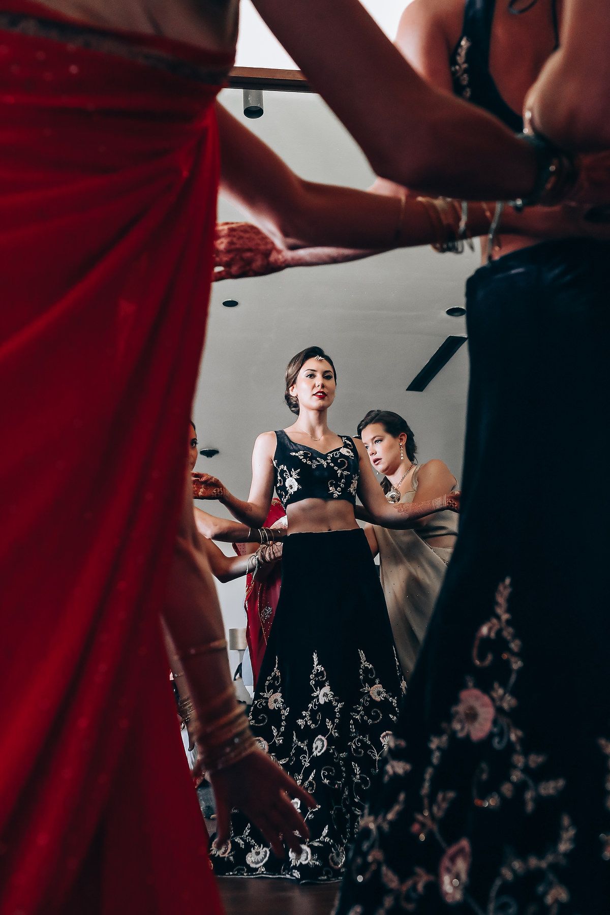 Wedding preparation scene with red curtain and formal attire.