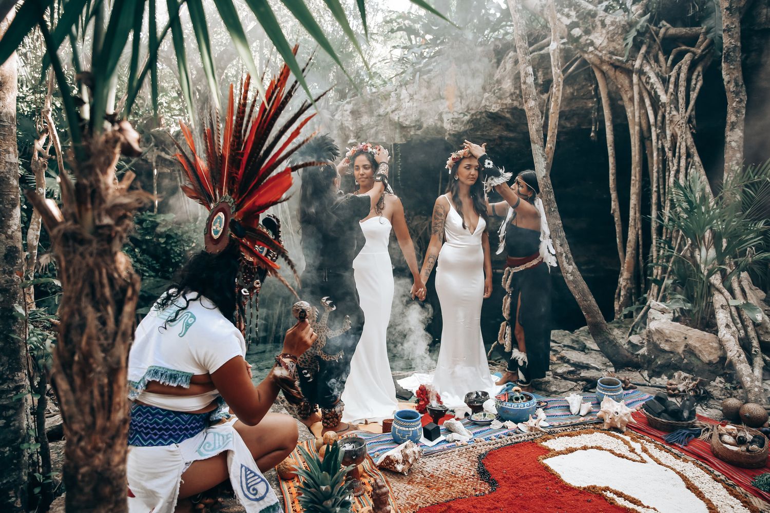 Ancient Mayan ritual performance in a tropical forest with traditional red feathered headdresses.