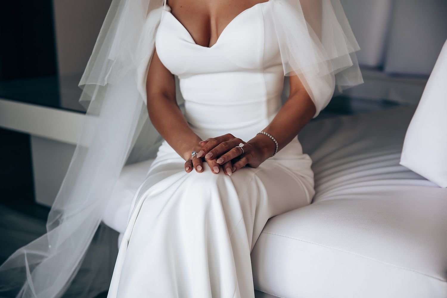 Close-up details of an elegant white wedding dress with a sweetheart neckline.