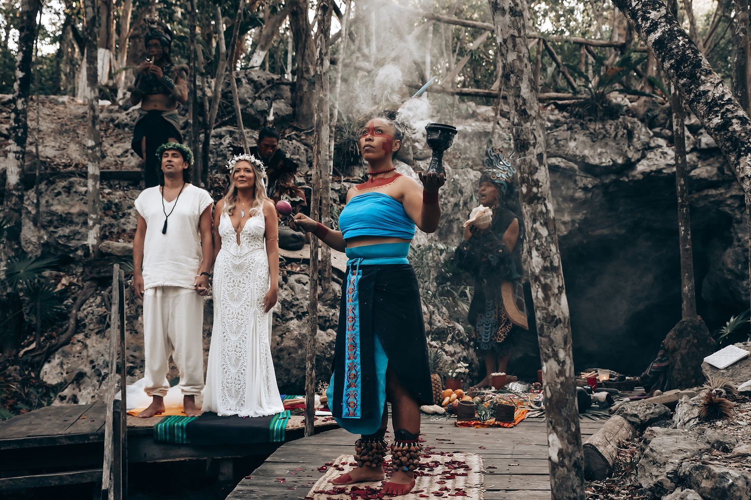 A group of people gather around stone ruins and walls at an ancient archaeological site.