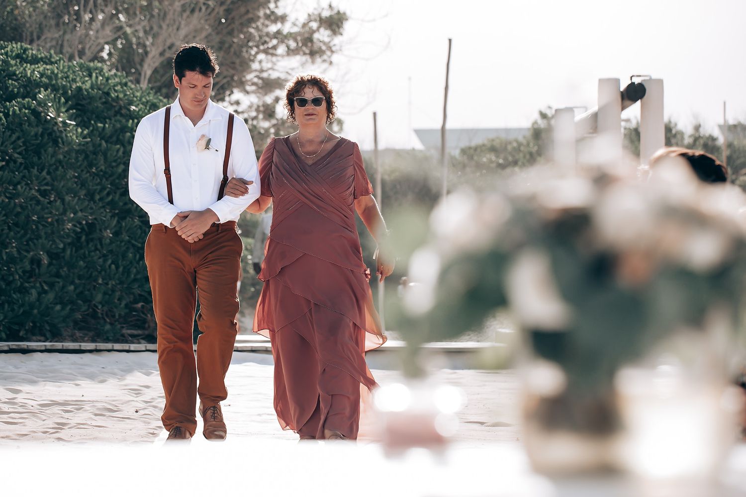 People walking together through an outdoor setting with soft focus and warm lighting effects.
