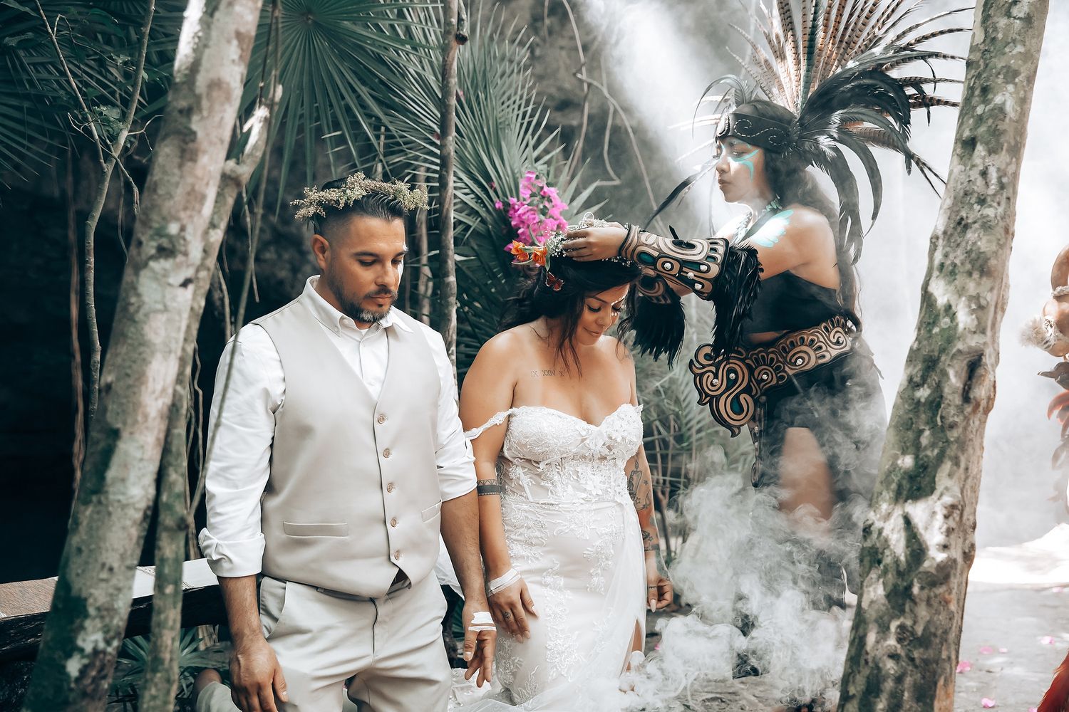 A couple dances together in a lush tropical garden setting with natural light streaming through the foliage.