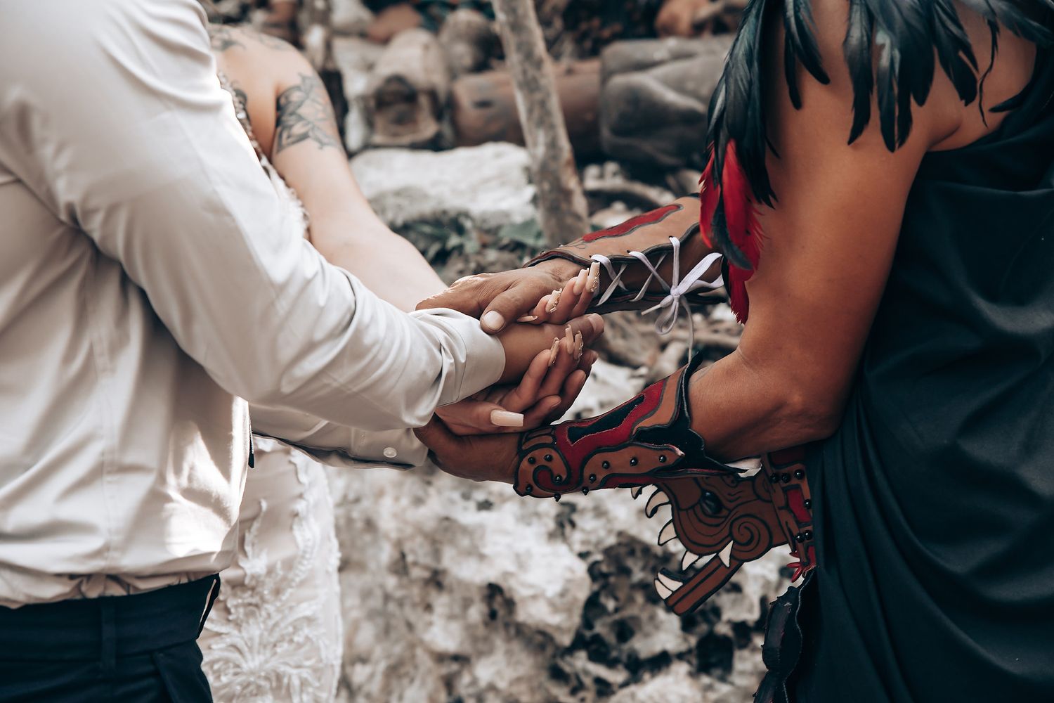 Wedding ceremony participants exchanging rings during an outdoor celebration.