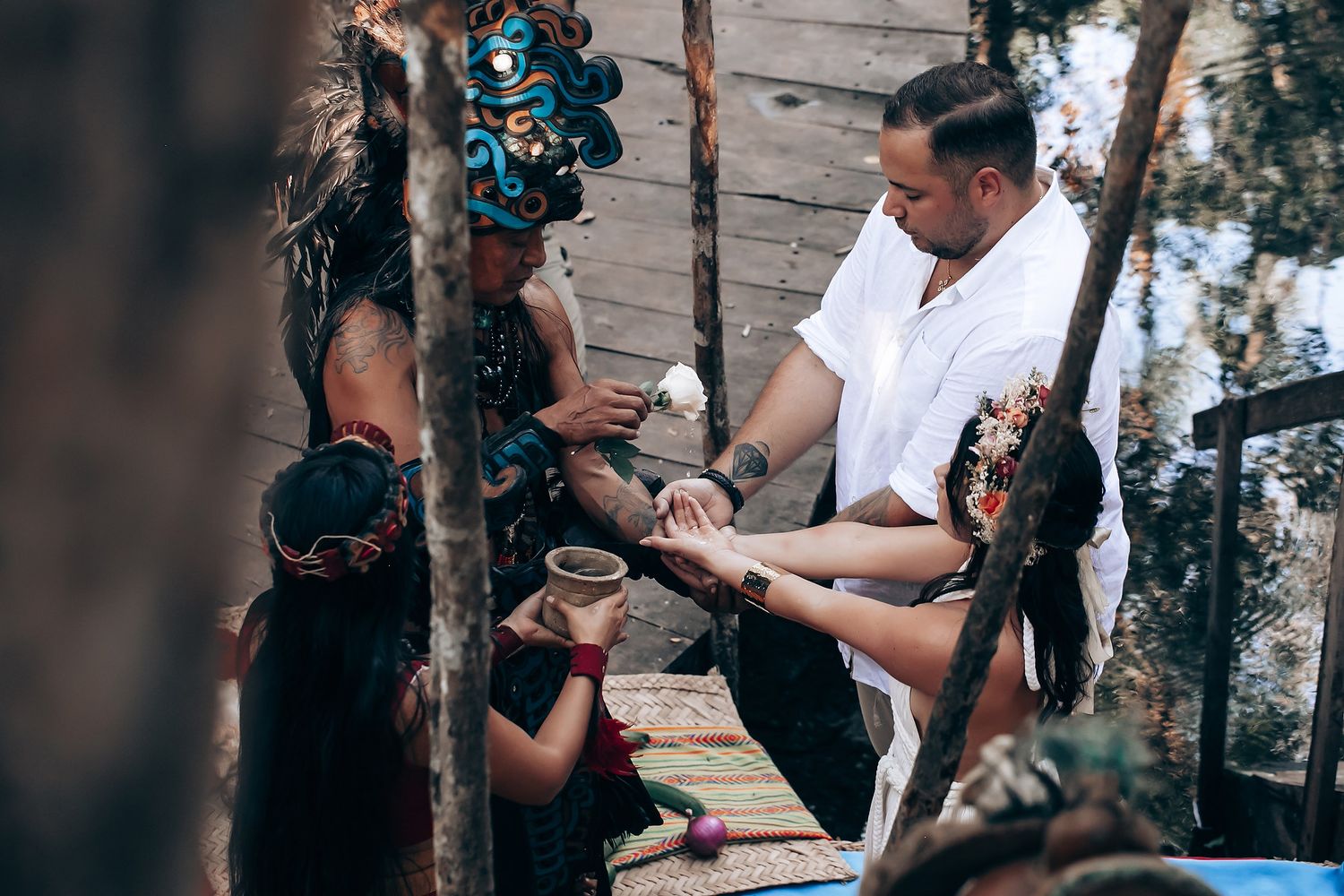 Intimate spiritual ceremony being performed in a wooded outdoor setting.