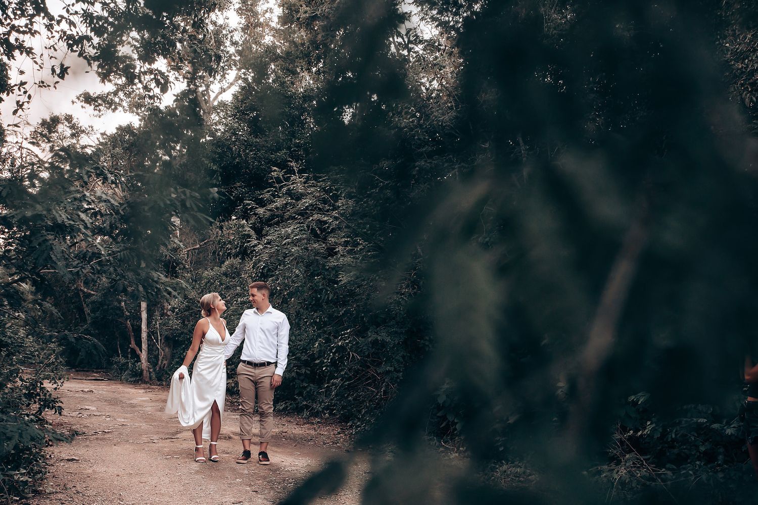Guests gathered outdoors for a celebration among trees and natural surroundings.