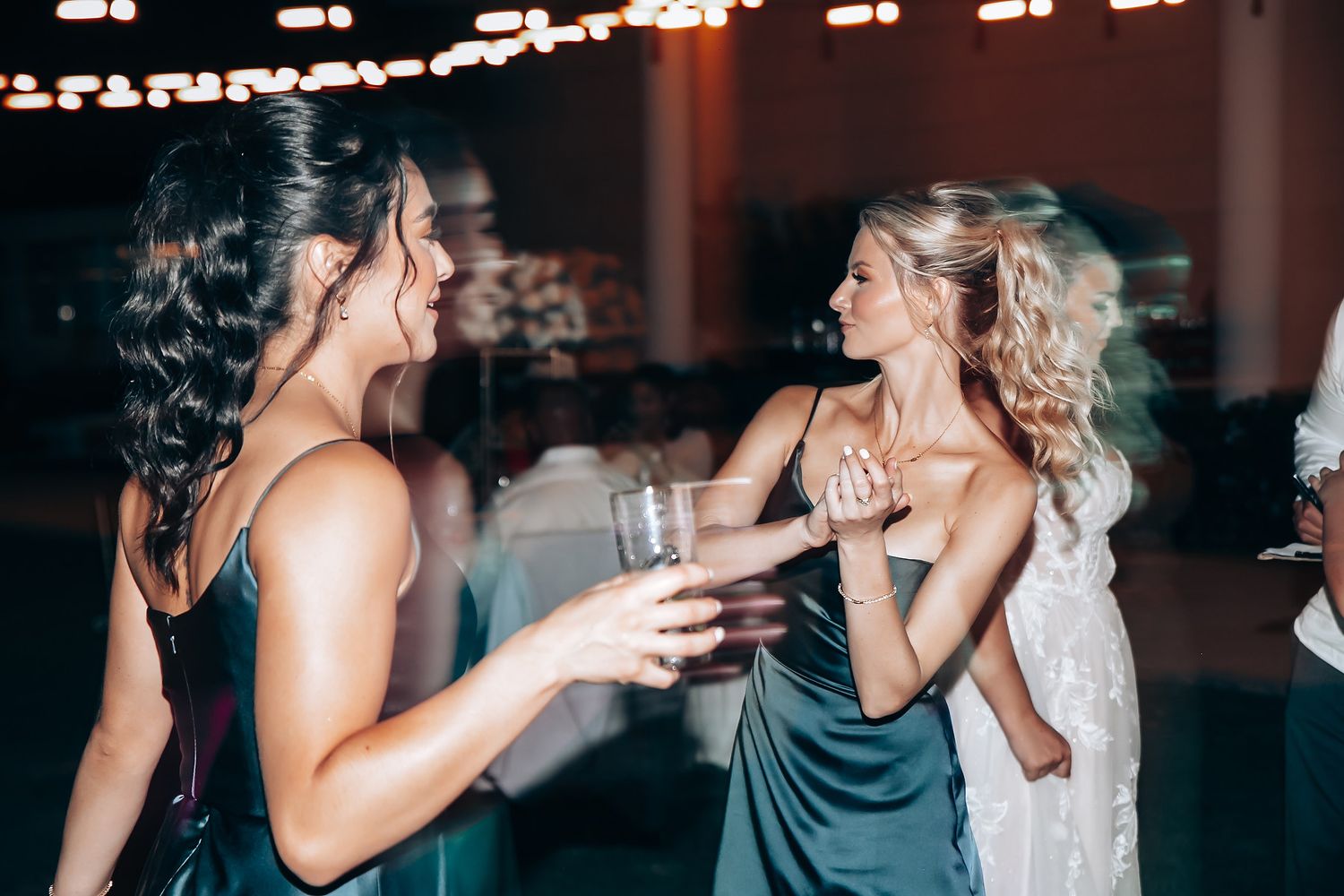 Wedding reception party with string lights creating a romantic nighttime atmosphere.