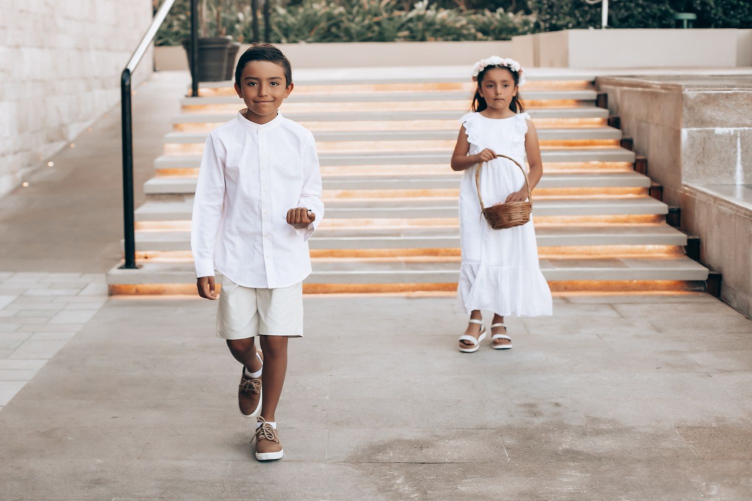 A sequence of images showing a child in white clothing running and playing on outdoor steps.