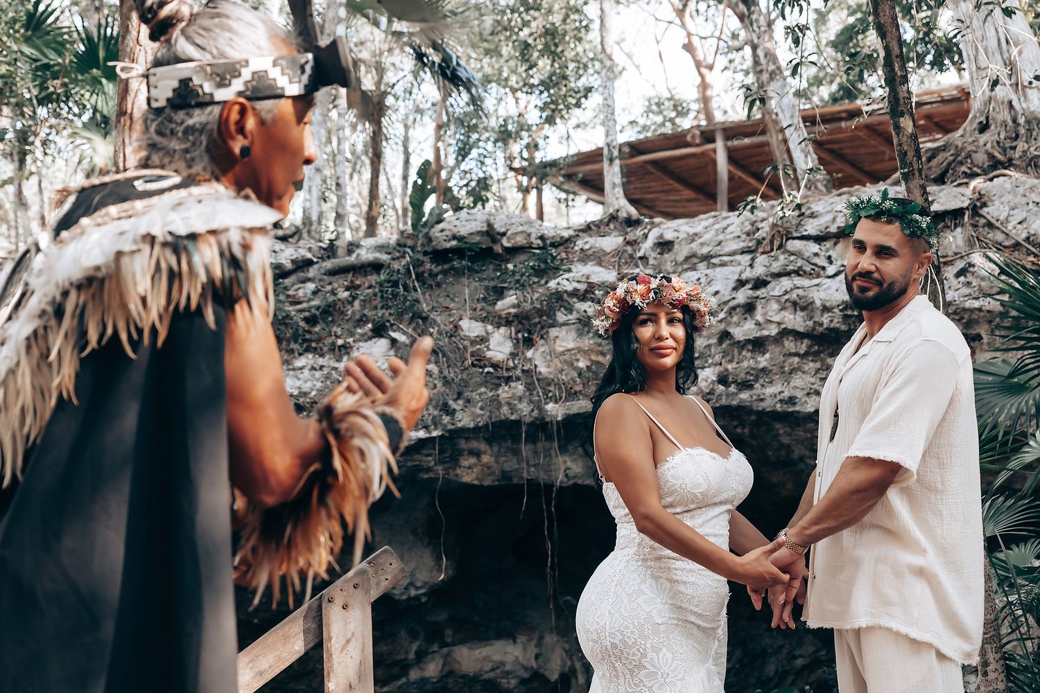 Romantic couple photoshoot in a scenic cave setting with natural light streaming through the rocky formations.