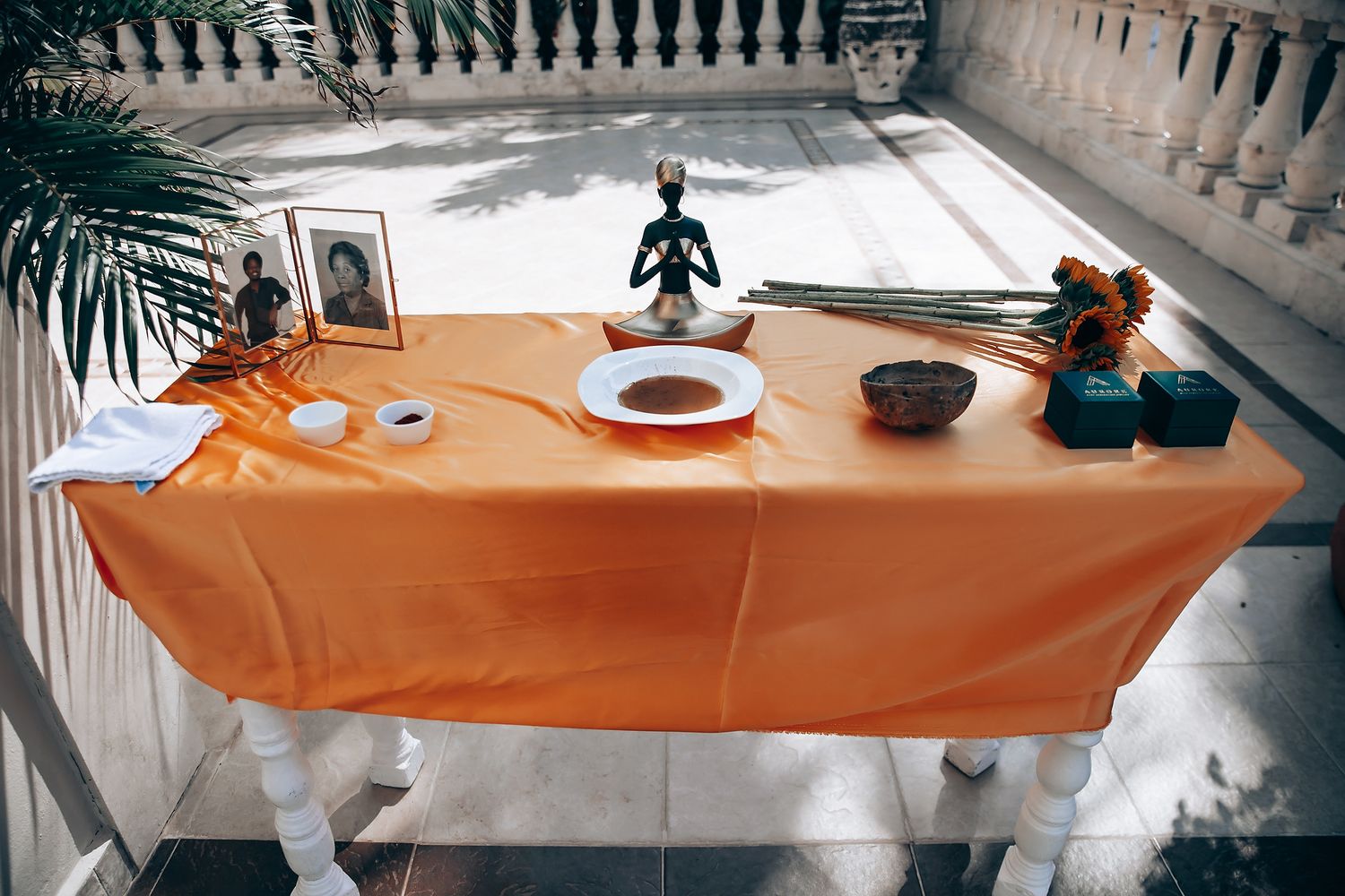 Interior balcony view with an orange tablecloth draped over a railing in a historic building.