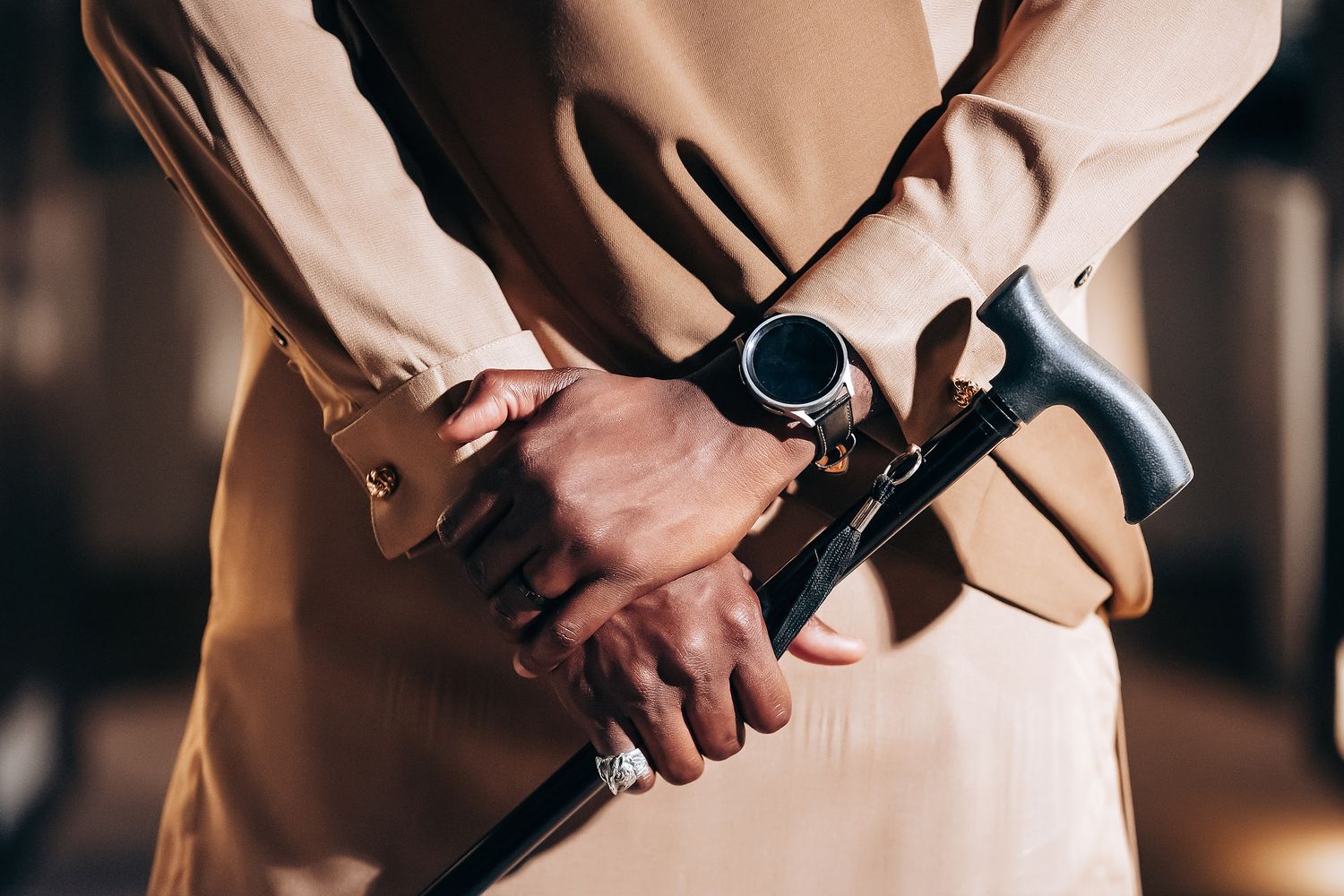 Close-up detail shot of formal attire and hands clasped together.