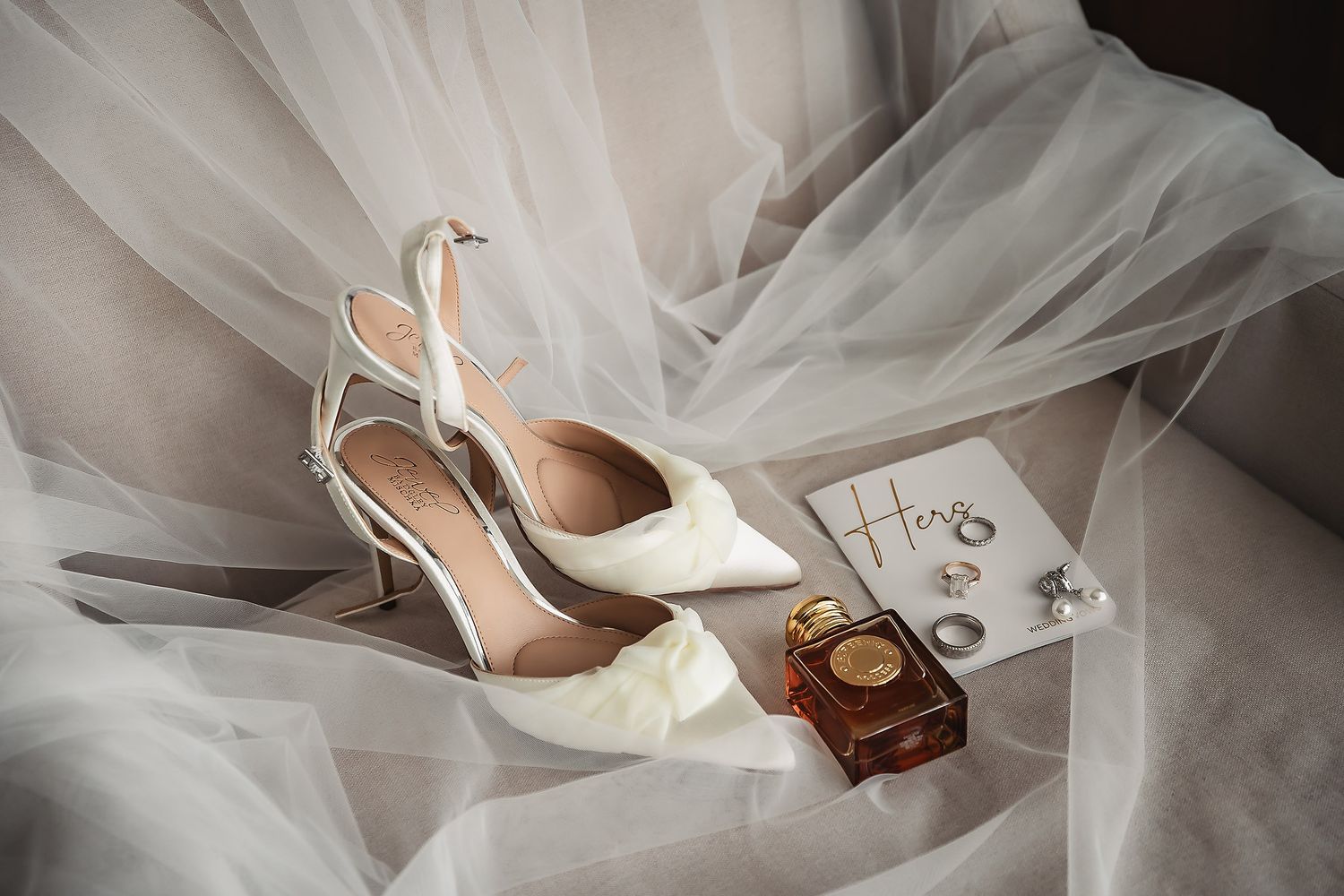 Close-up details of flowing white wedding dress tulle and fabric.