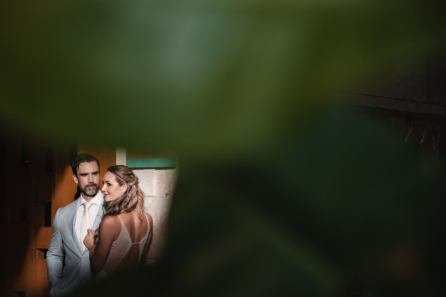 A romantic first look moment between a couple in a lush garden setting.