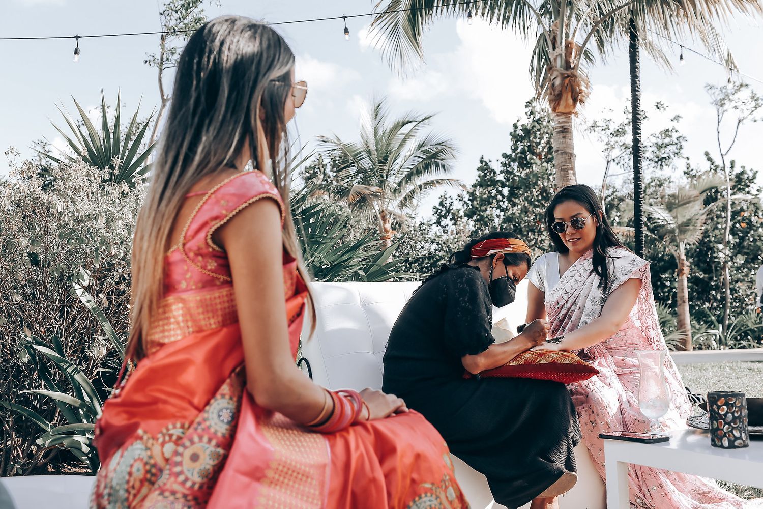 Wedding celebration photos with palm trees and string lights creating a tropical outdoor atmosphere.