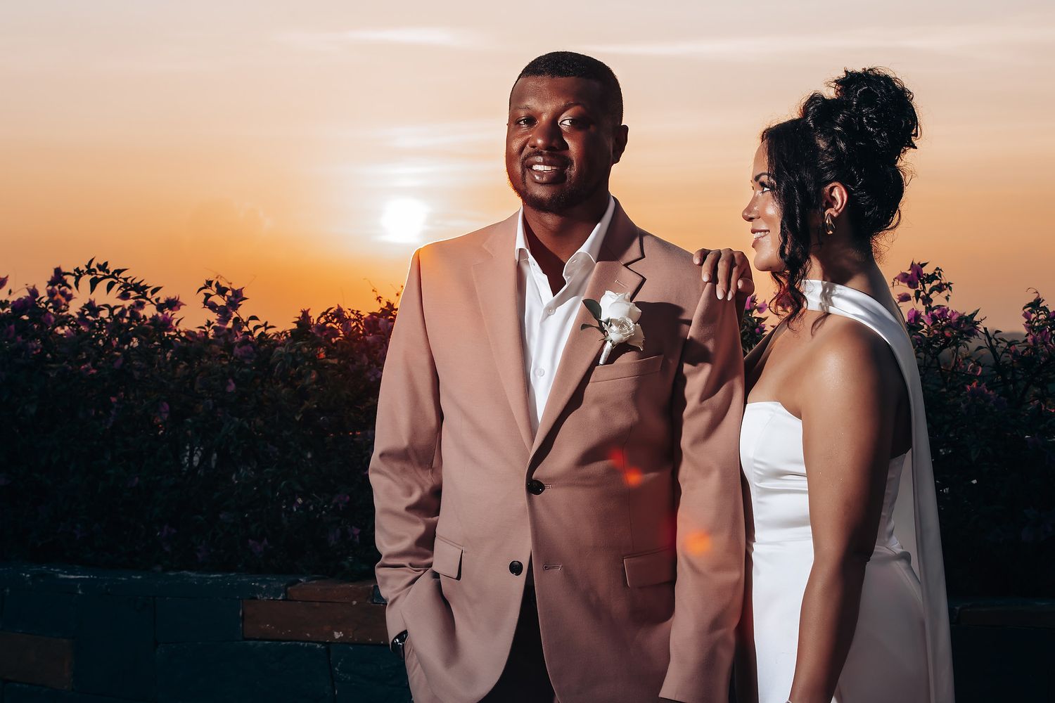 Elegant wedding portraits captured during golden hour sunset.