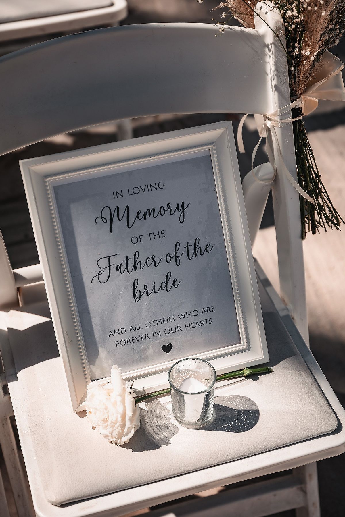 Framed memorial sign honoring the Father of the Bride at a wedding ceremony with candle.