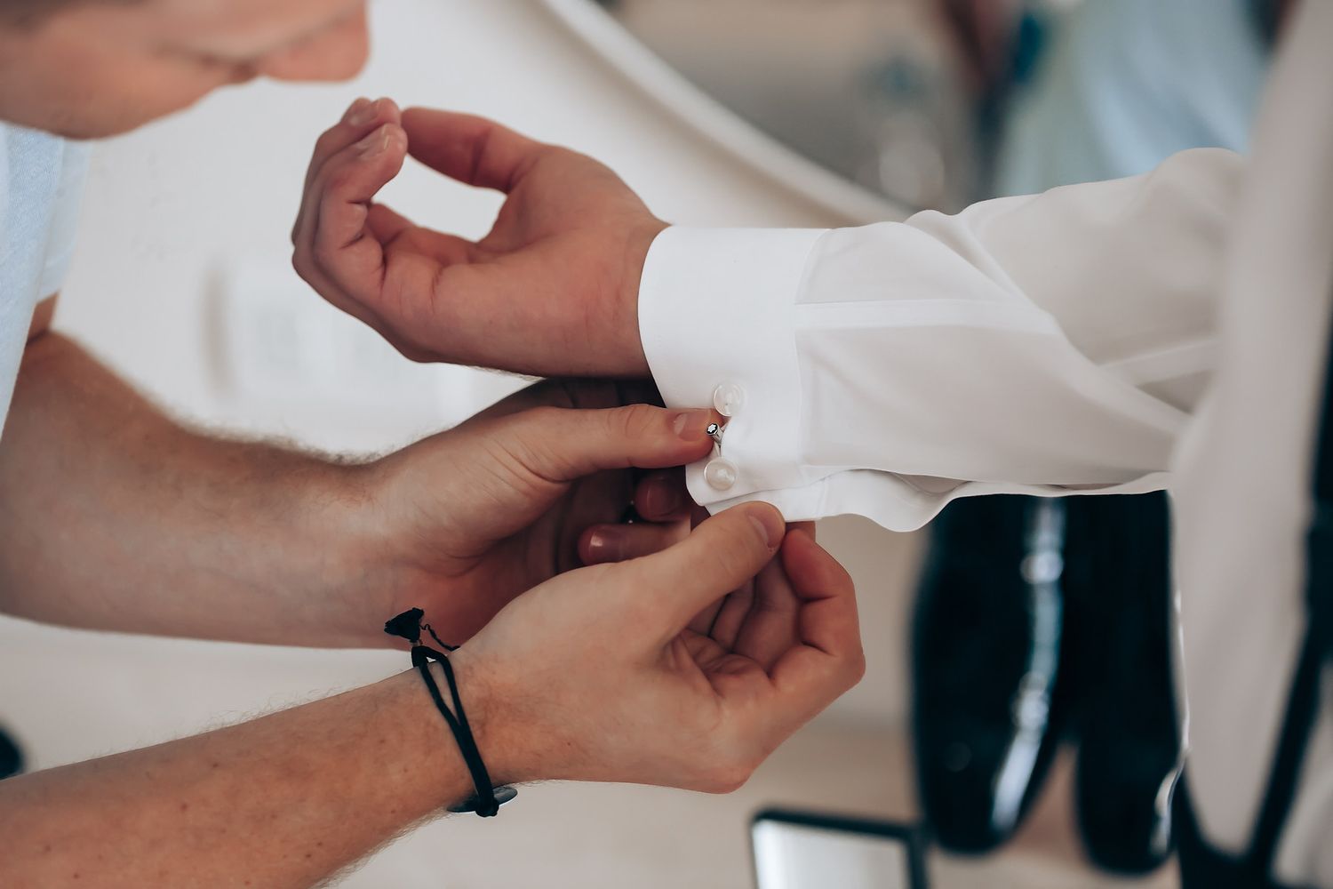 Close-up of hands exchanging wedding rings during an intimate ceremony.