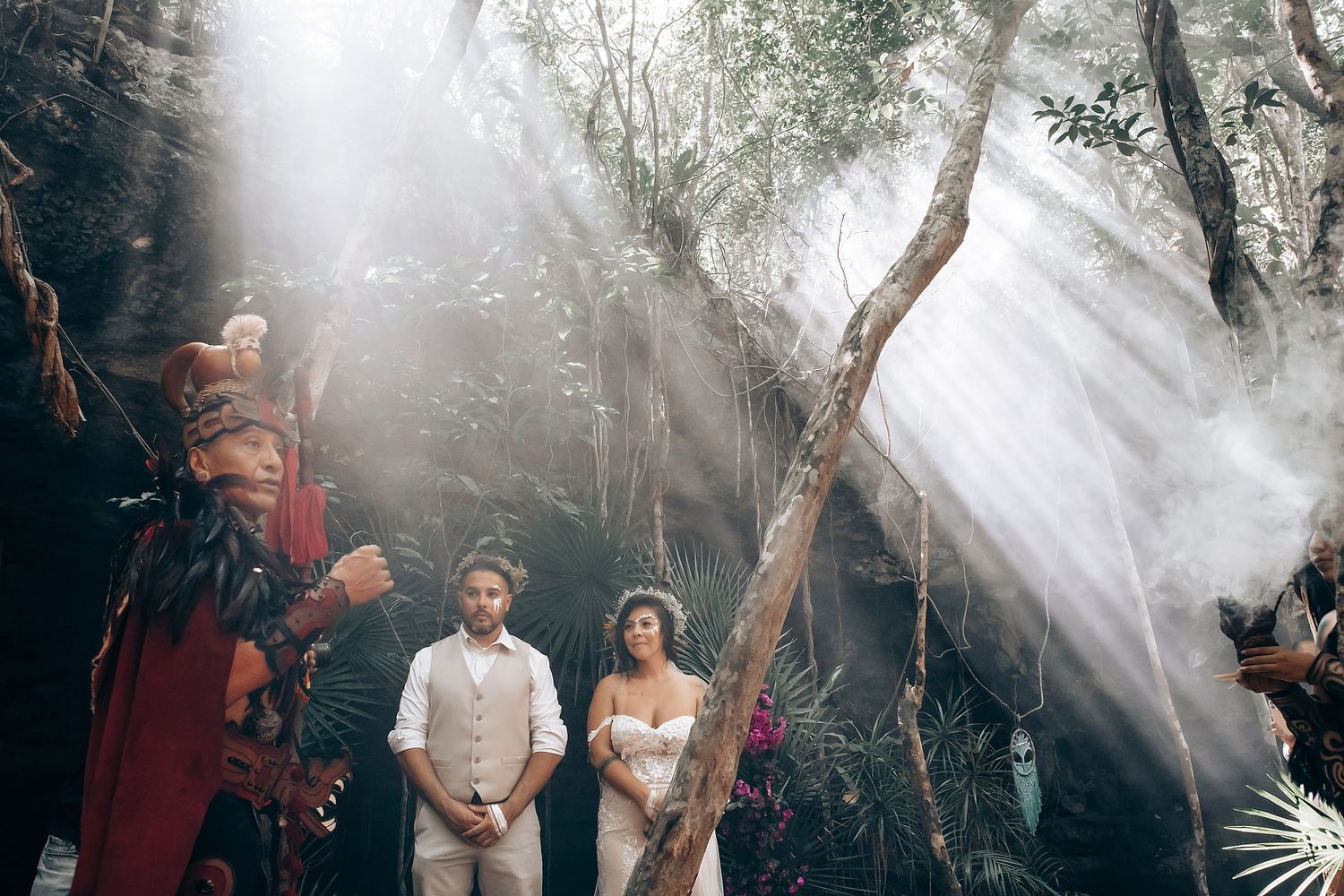 Atmospheric forest ceremony scene with smoke and sunbeams filtering through trees.