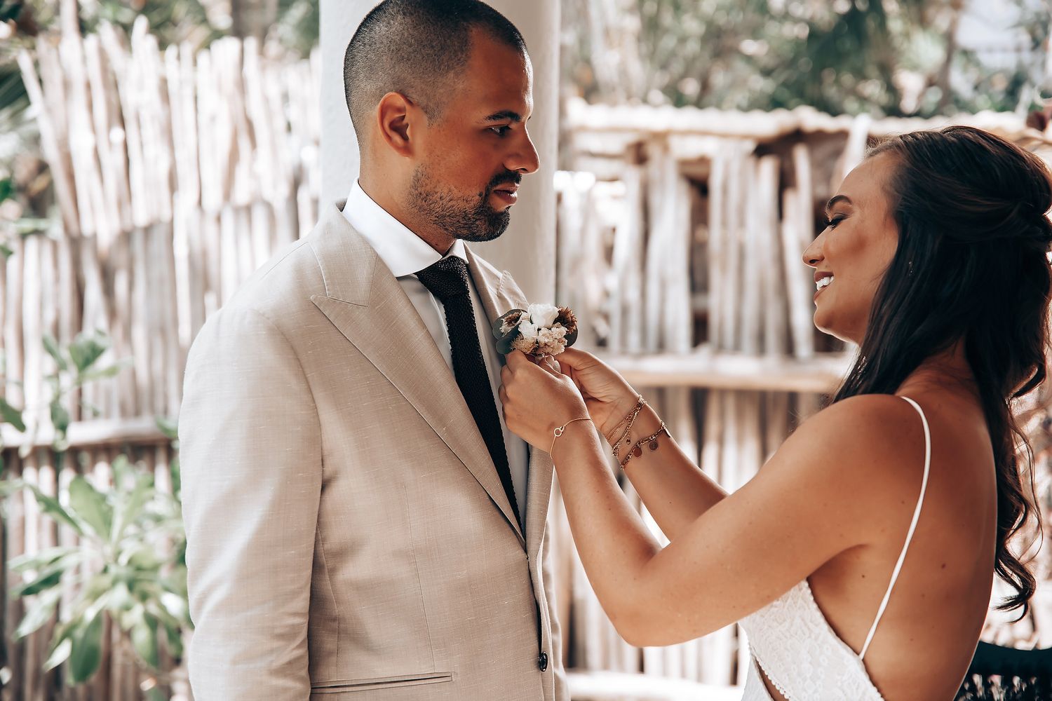 Romantic couple sharing tender moments in an outdoor setting with palm trees.