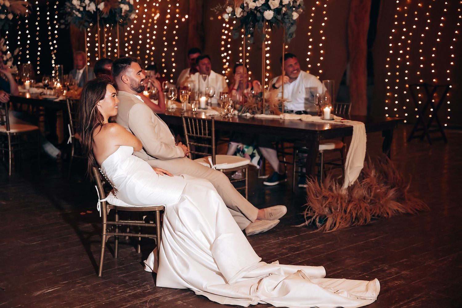 A sequence of dance moves at a wedding reception shows a couple performing a fun dip on the dance floor.