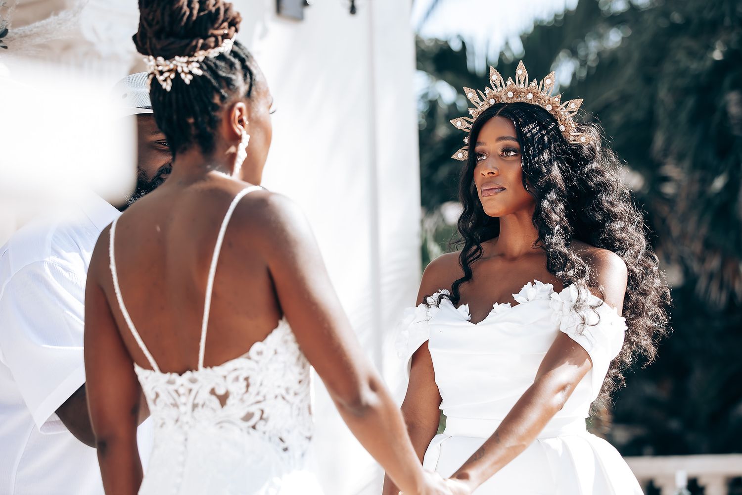 Joyful wedding celebration moments captured in white dresses against natural backdrop.