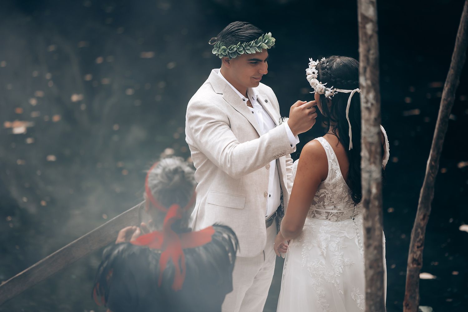 Atmospheric wedding ceremony in the woods with smoke effects and traditional elements.