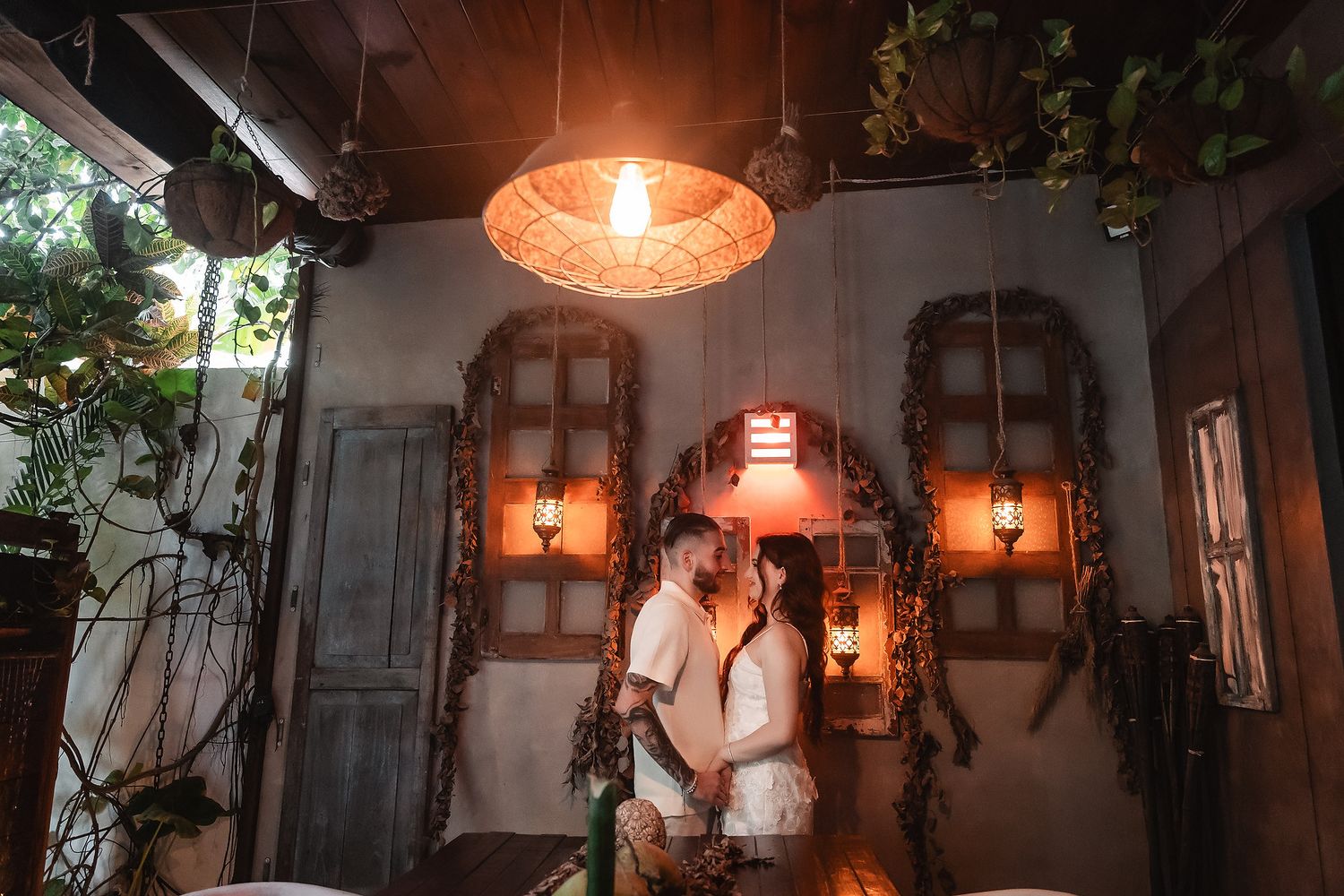 Warm ambient lighting from vintage-style lanterns creates a romantic atmosphere in an indoor space.