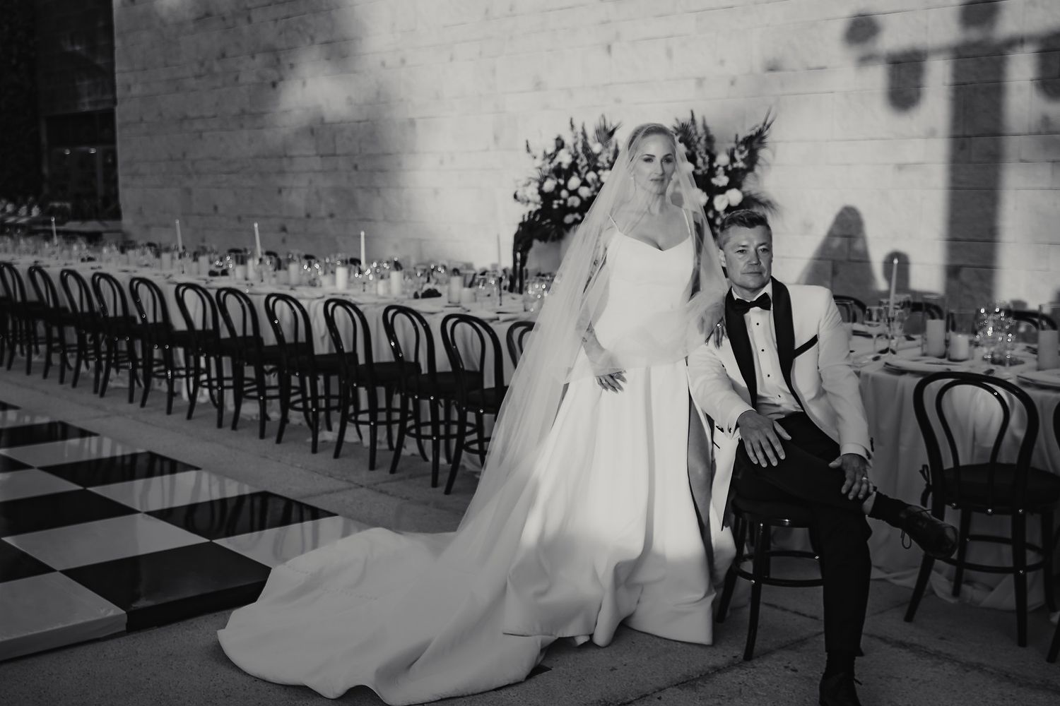 Black and white wedding ceremony shots showing silhouettes and venue details.