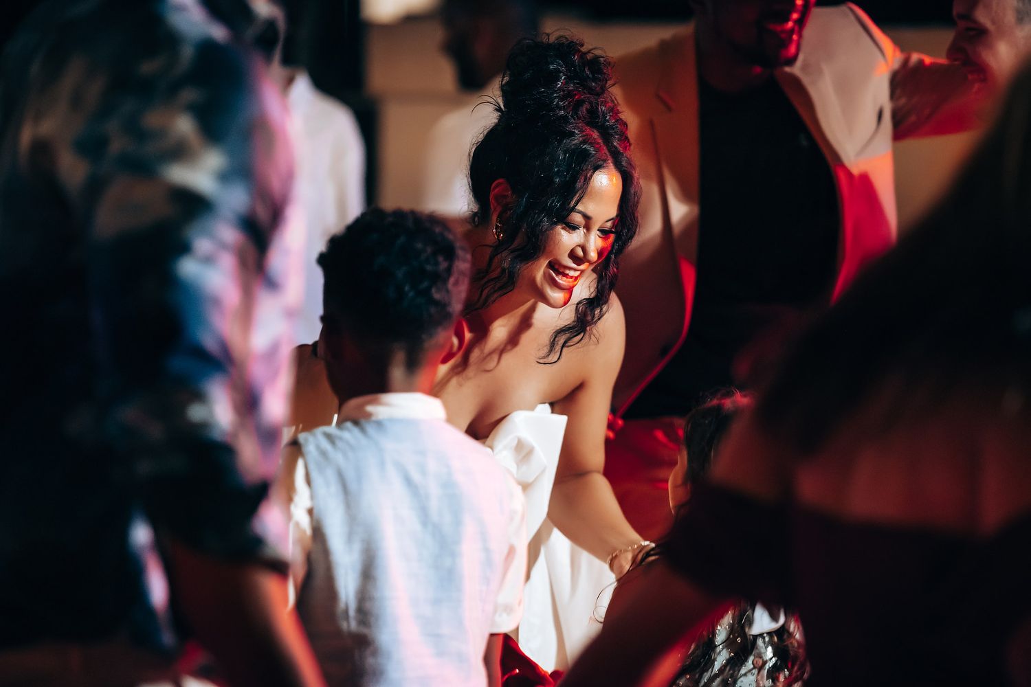 Guests dancing and celebrating at a lively wedding reception party.