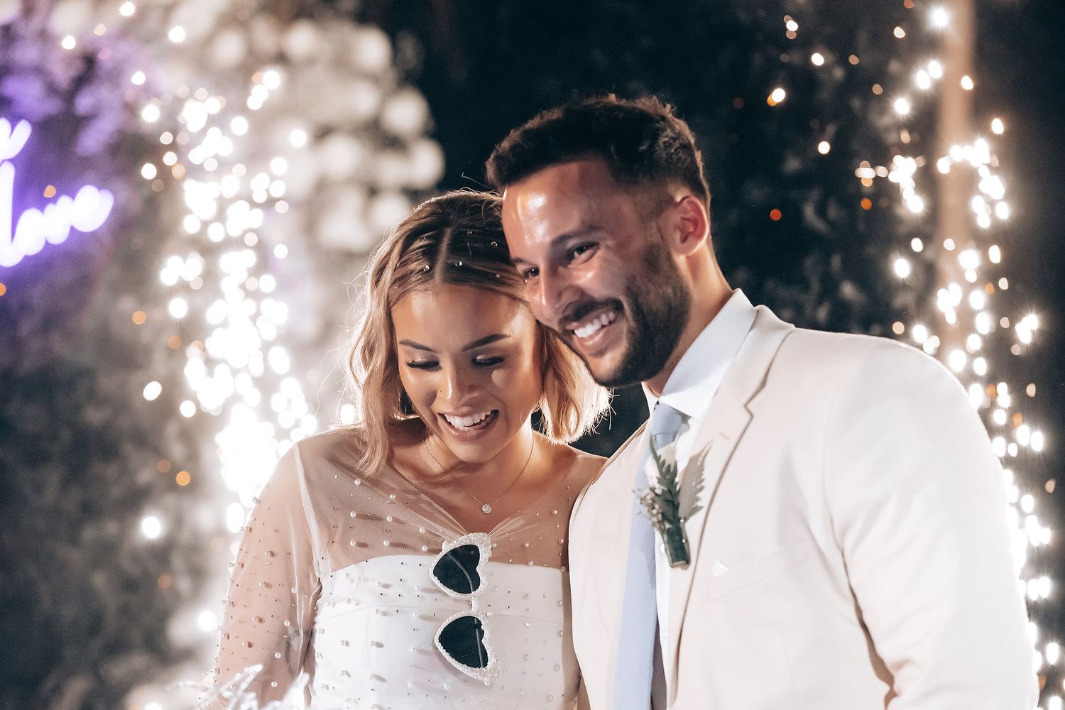 Romantic wedding celebration with sparklers creating magical light effects in the evening.
