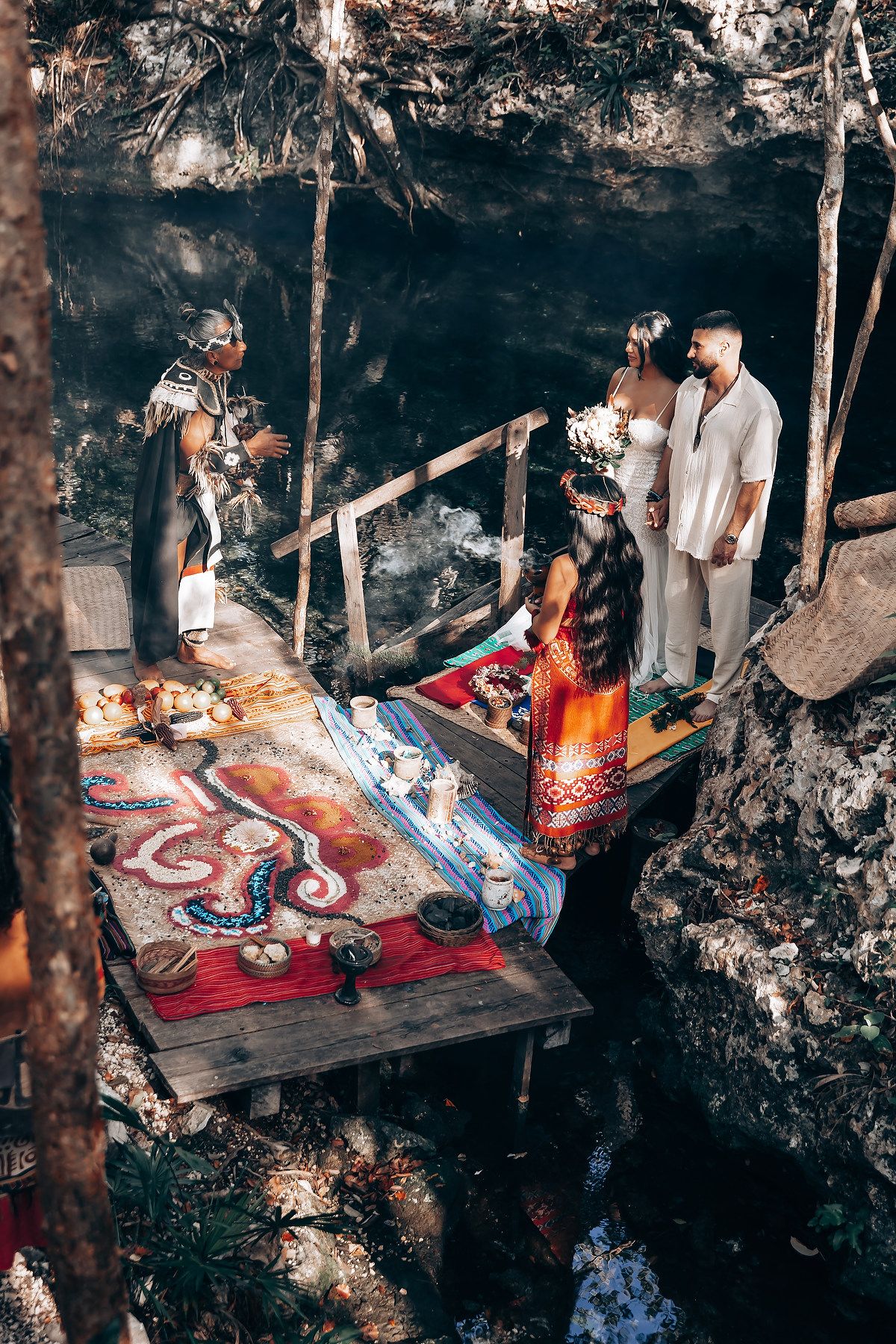 A cozy cave setting decorated with colorful rugs and soft lighting creates an intimate atmosphere.