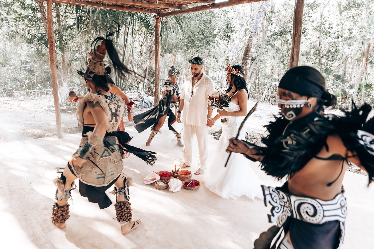 Wedding photographers capturing moments during an outdoor forest ceremony.