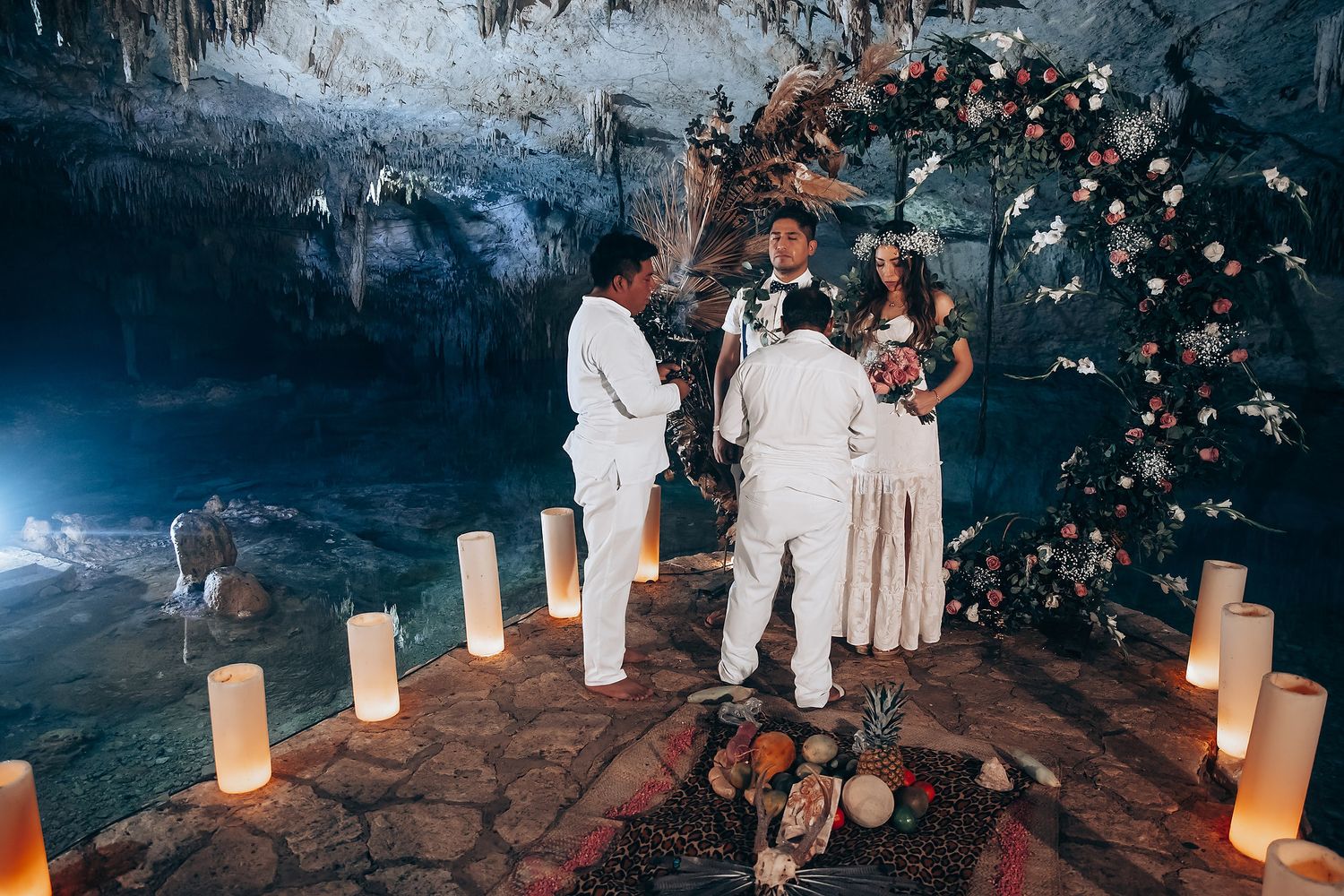 Romantic evening ceremony with glowing lanterns lining a stone pathway under twinkling lights.