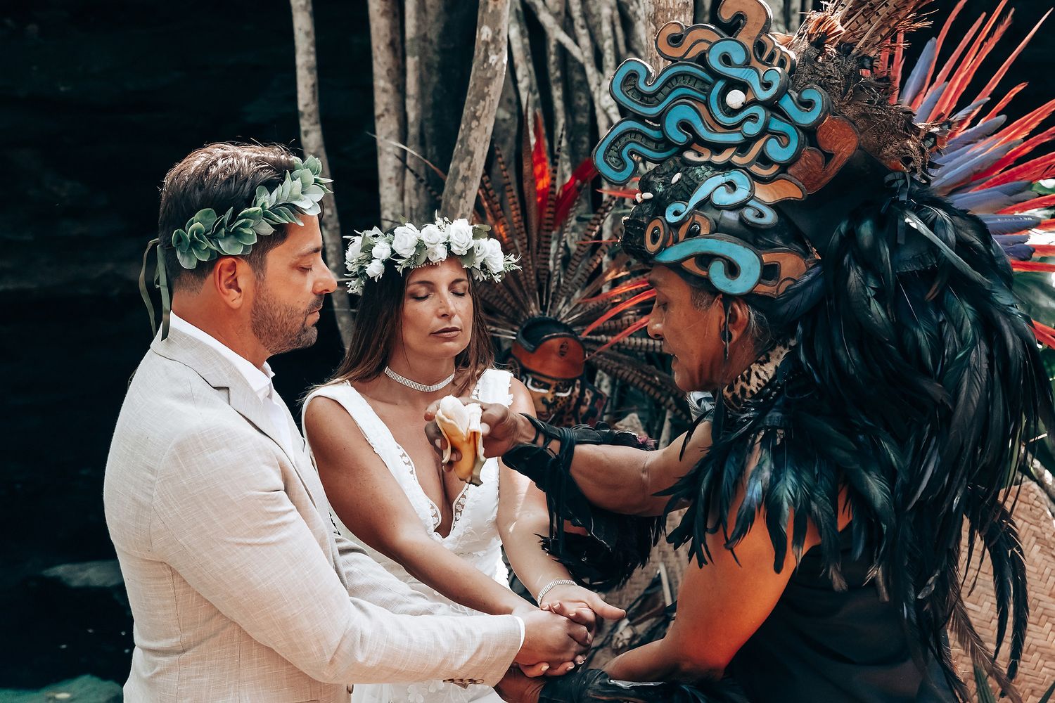 Wedding ceremony participants gather for a traditional Mayan blessing ritual.