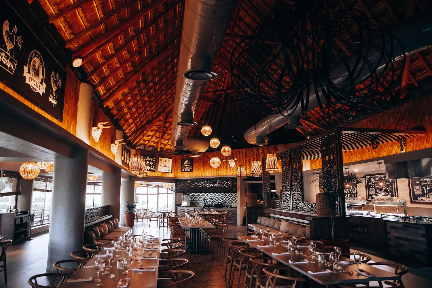 Rustic wedding reception venue with wooden beams and ambient lighting.
