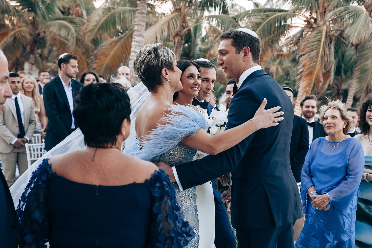 Wedding guests dancing and celebrating during a lively reception.