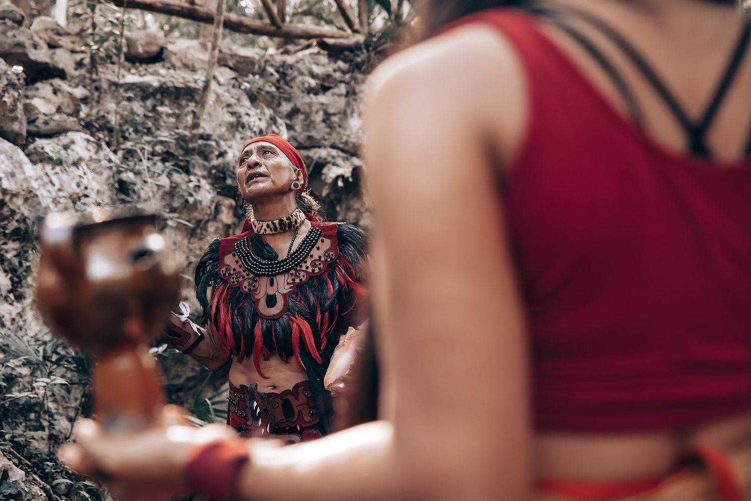 Couple sharing an intimate dance moment outdoors with guests watching in the background.
